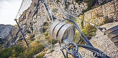 Protection wire mesh against falling rocks from the mountains. Editorial Stock Photo