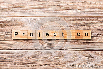 PROTECTION word written on wood block. PROTECTION text on wooden table for your desing, concept Stock Photo