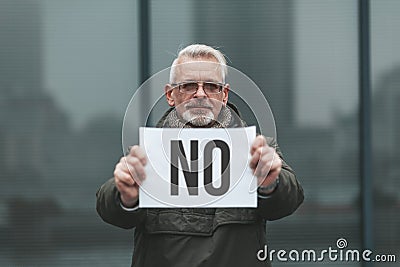 Protest - no! An adult man with a poster in his hands, one activist outside Stock Photo
