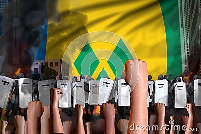 Protest in Saint Vincent and the Grenadines - police swat stand against the angry crowd on flag background, mutiny fighting Stock Photo