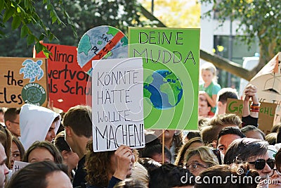 Protest sign saying `Could. Might. Would. Do!` in German held up by young people during Global Climate Strike / Fridays for future Editorial Stock Photo