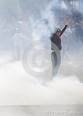 Protester amid tear gas thrown by the police. Editorial Stock Photo