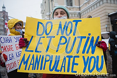 Protester holding poster on prostest against Russian agression. Helsinki, Finland, 7.02.2022 Editorial Stock Photo