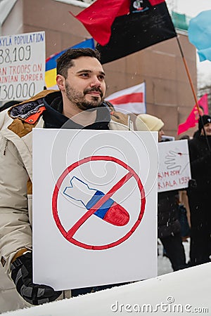 Protester holding poster in prostest against Russian agression. Helsinki, Finland, 7.02.2022 Editorial Stock Photo