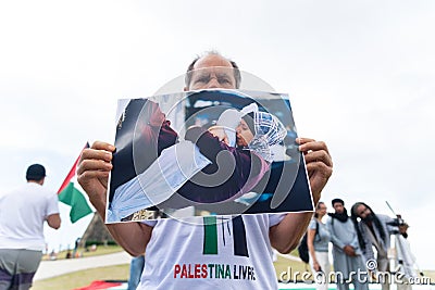 Protester holds a photo of the war in Palestine during a protest in the city of Salvador, Bahia Editorial Stock Photo