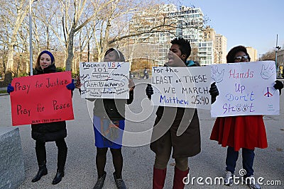 A protester holds a sign during a march against police brutality and grand jury decision on Eric Garner case on Grand Army Plaza Editorial Stock Photo