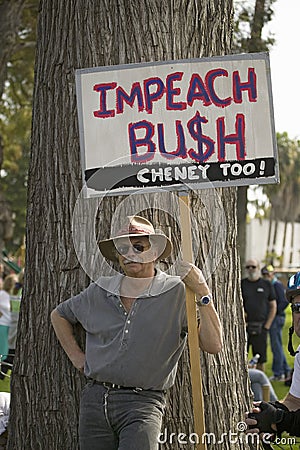 A protester holds a sign reading Editorial Stock Photo