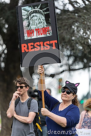 Protester holds a sign that reads, `Why Trump? RESIST` Editorial Stock Photo