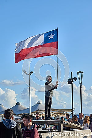 Puerto Montt, Chile; Oct 25, 2019: Protesters with Chilean flag at Puerto Montt Editorial Stock Photo