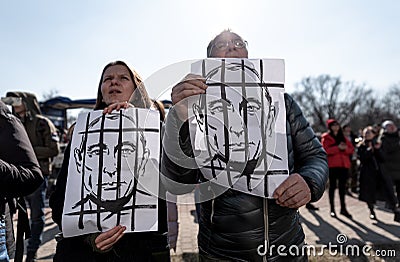 Protesters holding picture of Putin. Stand with Ukraine demonstration Editorial Stock Photo