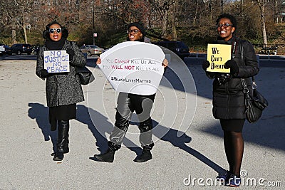 Protesters march against police brutality and grand jury decision on Eric Garner case on Grand Army Plaza in Brooklyn Editorial Stock Photo