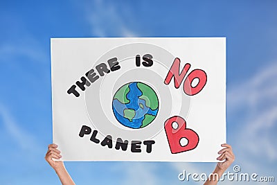 Protestor holding placard with text There Is No Planet B against blue sky, closeup. Climate strike Stock Photo