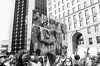 Protestor Holds Up Pictures of African Americans Killed by Police Officers Editorial Stock Photo