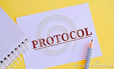 PROTOCOL word written on white paper. Protocol concept, with a focus on the expected gains, a standard set of rules Stock Photo