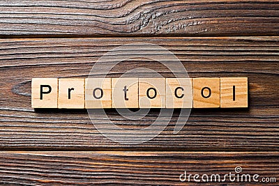PROTOCOL word written on wood block. PROTOCOL text on wooden table for your desing, concept Stock Photo