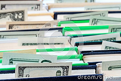 Protruding from the pages of books money, books stand in rows Stock Photo