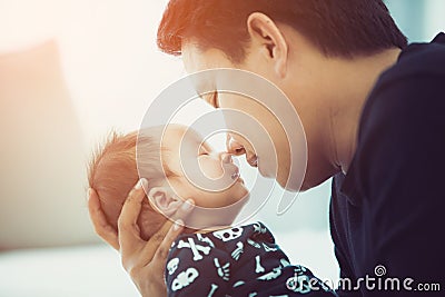 Proud asian father holding his newborn baby at home. Stock Photo