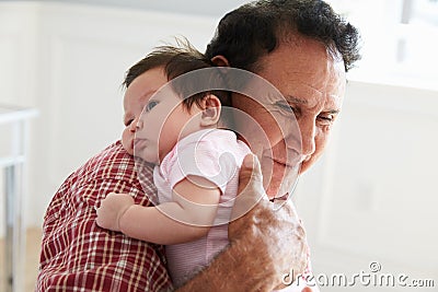 Proud Grandfather Holding Baby Granddaughter Stock Photo