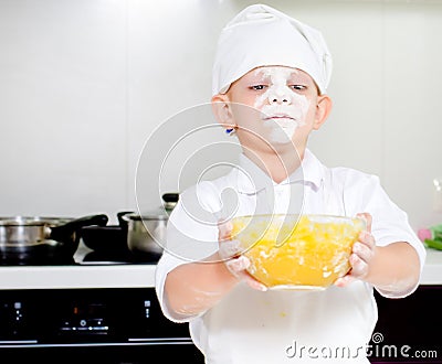 Proud little boy chef with a face full of flour Stock Photo