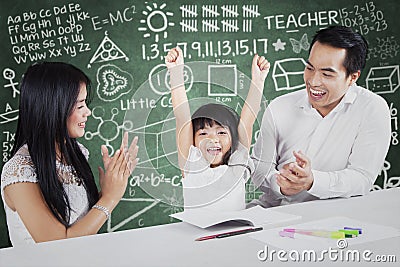 Proud parents giving applause on their child Stock Photo