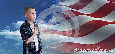 Proud Patriotic kid looks at American flag Stock Photo