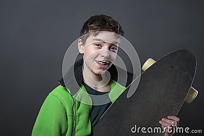 Proud smiling teenage boy holding his long board Stock Photo