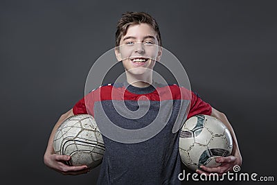 Proud, smiling teenage boy holding two soccer ball's Stock Photo