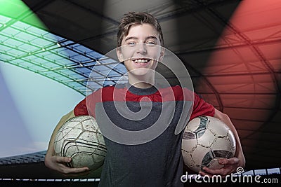 Proud, smiling teenage boy holding two soccer ball's Stock Photo