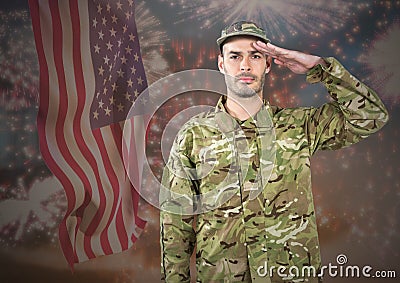 Proud soldier saluting against fluttering american flag and fireworks in background Stock Photo