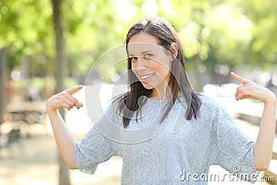Proud woman pointing herself in a park Stock Photo