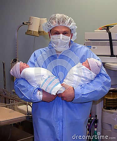 Proud young father with twins Stock Photo