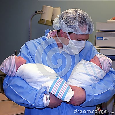 Proud young father with twins Stock Photo