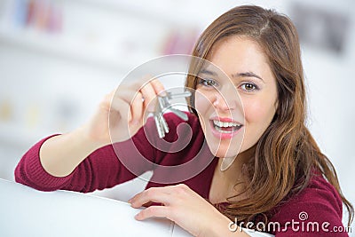 Proud young woman holding up set house keys Stock Photo
