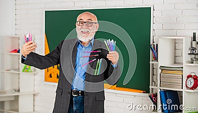 Provide customised education to deliver right content at right time. Senior intelligent man teacher at chalkboard Stock Photo