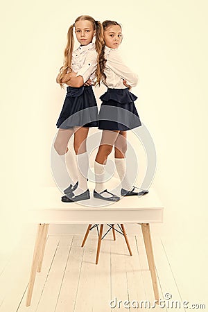 Providing children with education. Small children standing on table in classroom. Little children enjoying school break Stock Photo