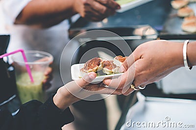 Providing free food to the poor : The hands of beggars receive donated food Stock Photo