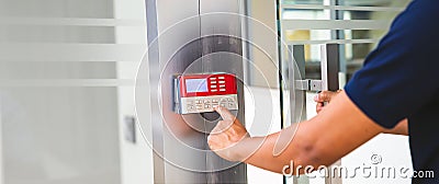 Proximity card reader door unlock, Close up hand security man using fingerprint scanning on access control system for identity Stock Photo