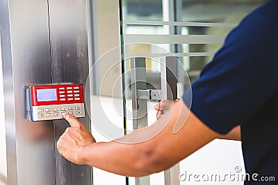 Proximity card reader door unlock, Close up hand security man using fingerprint scanning on access control system for identity Stock Photo