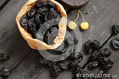 prunes and yellow cherries on a dark background Stock Photo