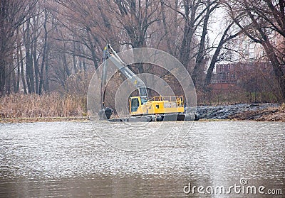 Pryluky, Chernihiv, Ukraine - 11/19/2020: Amphibious Excavators. River Cleaning. Editorial Stock Photo