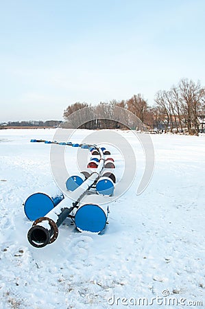 Pryluky, Chernihiv, Ukraine - 01/19/2021: Dredging machine on a frozen winter river Editorial Stock Photo