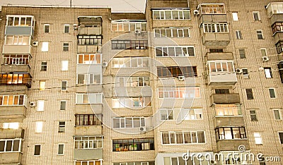 Pryluky, Chernihiv, Ukraine - 02/15/2021: Multi-storey brick house in the evening with lights in the windows Editorial Stock Photo