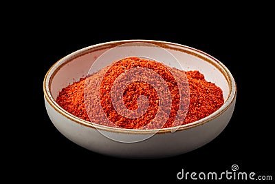 PSD ground paprika in a bowl isolated on black Stock Photo
