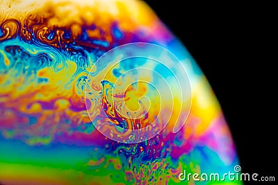 Psychedelic abstract planet from soap bubble, Light refraction on a soap bubble, Macro Close Up moving particles Rainbow colors on Stock Photo