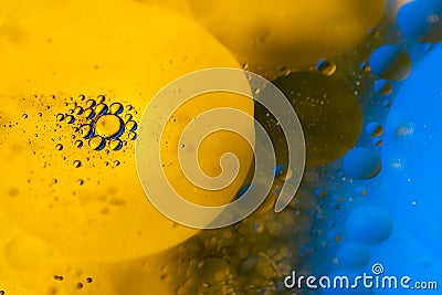 Psychedelic blueand yellow oil and water abstract background. Abstract colorful background. Foam of Soap with Bubbles macro shot. Stock Photo