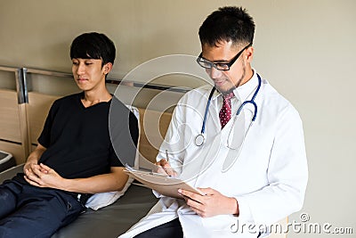 psychiatrist doctor disuss wtih patient on bed Stock Photo