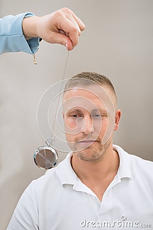 Psychiatrist Hypnotizing Patient With Pendulum Stock Photo