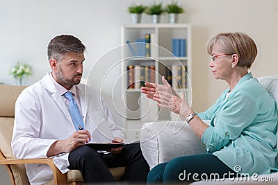 Psychiatrist listening his female patient Stock Photo