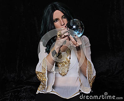 Psychic Fortune Teller With Crystal Ball on Black Background Stock Photo