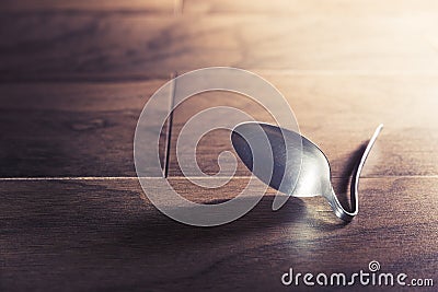 Psychokinesis concept with bent spoon Stock Photo